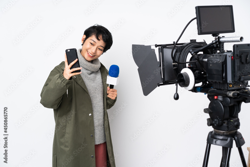 Reporter Vietnamese woman holding a microphone and reporting news making a selfie