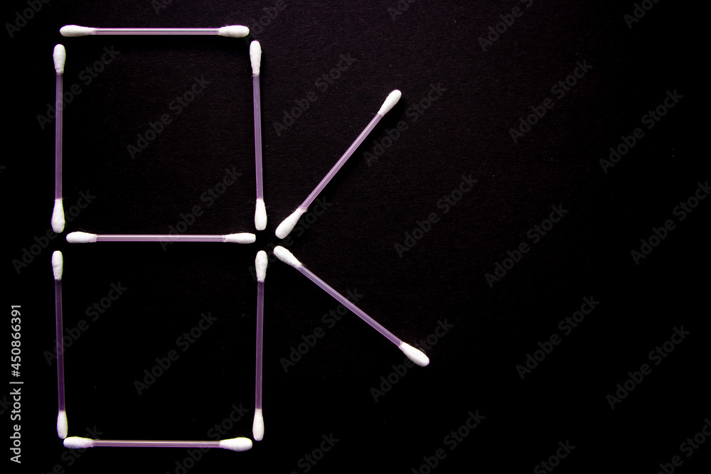 a lot of cotton buds on black background a lot of cotton buds on black background