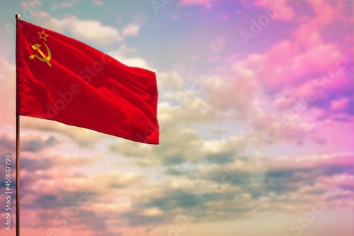 Fluttering Soviet Union (SSSR, USSR) flag mockup with the space for your content on colorful cloudy sky background.