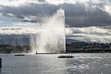 Geneva skyline with famous water jet fountain and Geneva lake in backlight, Switzerland
