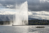 Geneva skyline with famous water jet fountain and Geneva lake in backlight, Switzerland