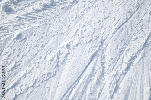Pattern on white snow. Ski tracks. 
