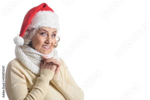 Portrait of senior woman in Santa hat isolated