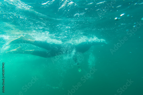 Athlete in a wetsuit swims in a lake © DZiegler
