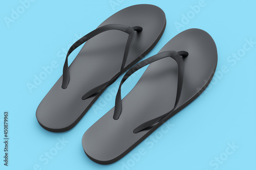 Beach black flip-flops or sandals isolated on blue background.