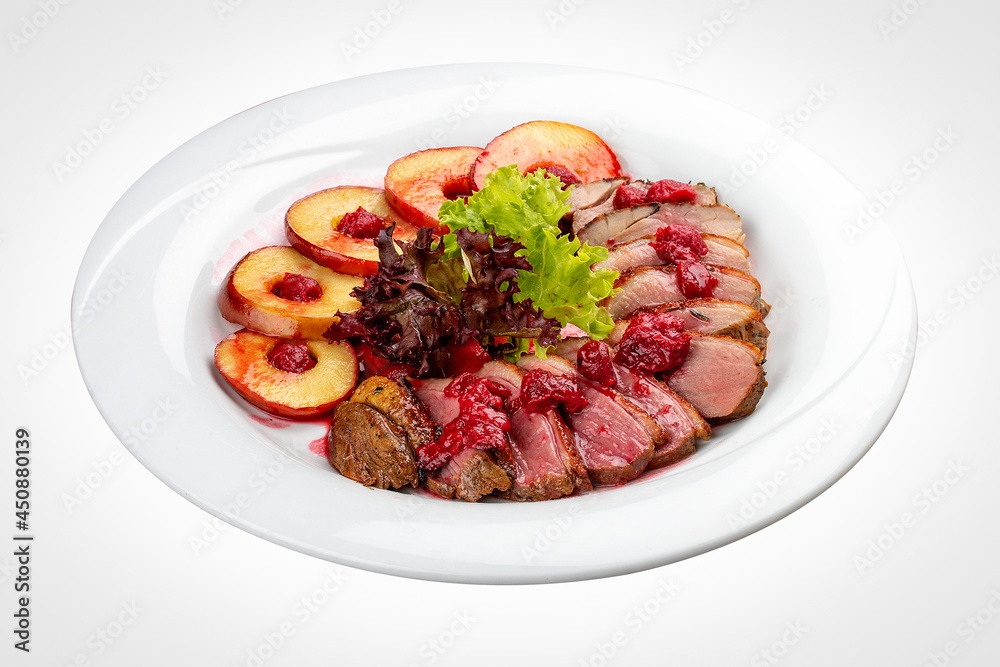 Duck breast mangre with berry confit and baked apple. On a white background Duck breast mangre with berry confit and baked apple. On a white background
