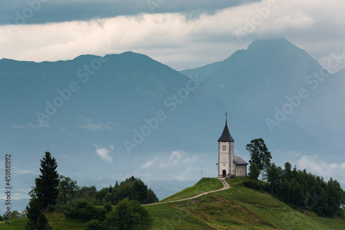 Jamnik Church of Saint Primoz with Alps Mountains in Background in Slovenia