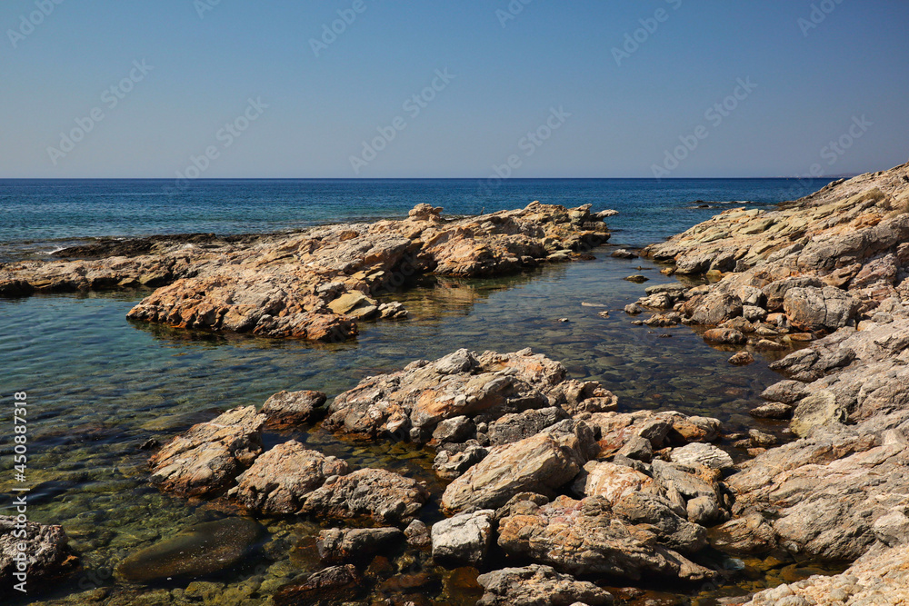 Stones in Aegean Sea during Sunny Day in Rhodes. Beautiful View of Rock in Water in Greece.