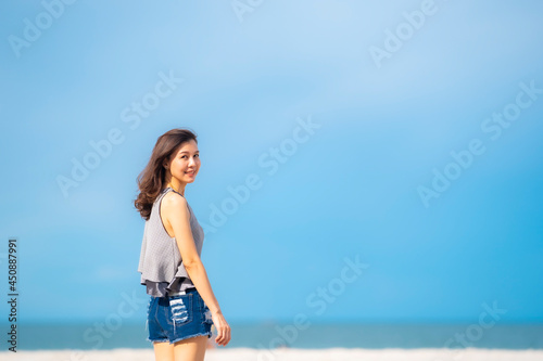Portrait beautiful Asian woman walking at tropical beach and blue sky