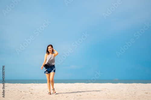 Wallpaper Mural Portrait beautiful Asian woman walking at tropical beach and blue sky Torontodigital.ca