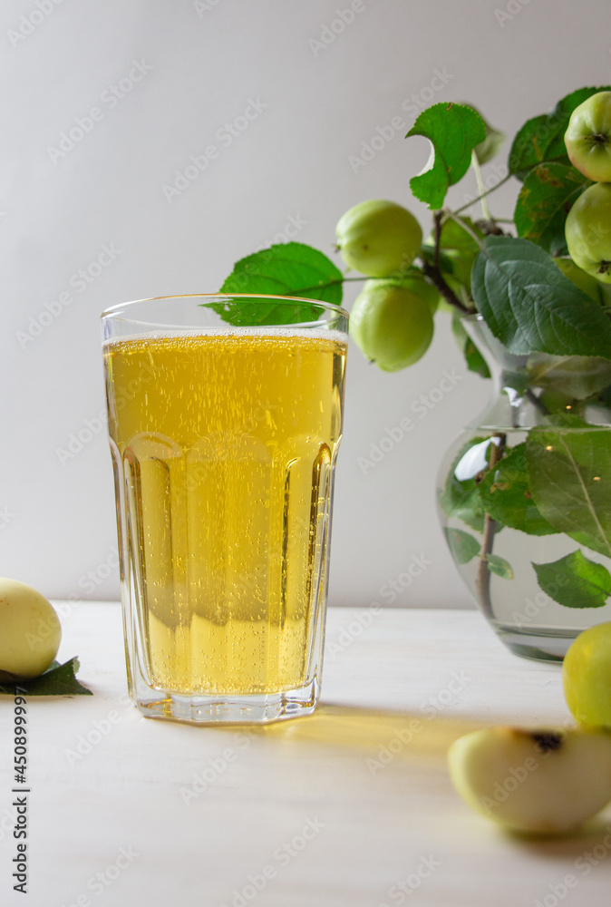 Apple cider sparkling in glass on white background Apple cider sparkling in glass on white background