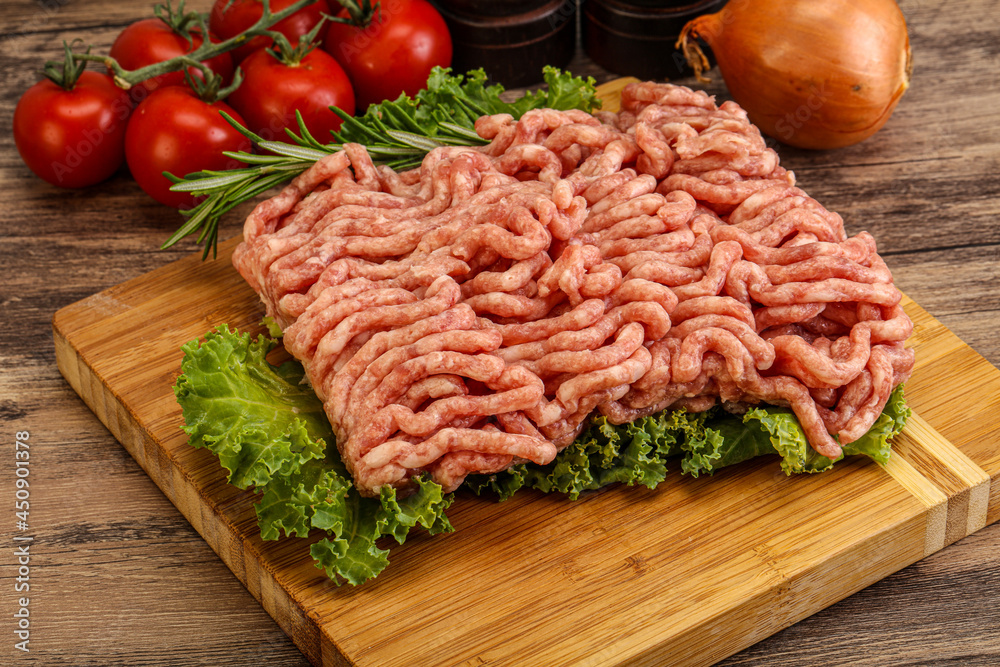 Raw pork minced meat over board Raw pork minced meat over board
