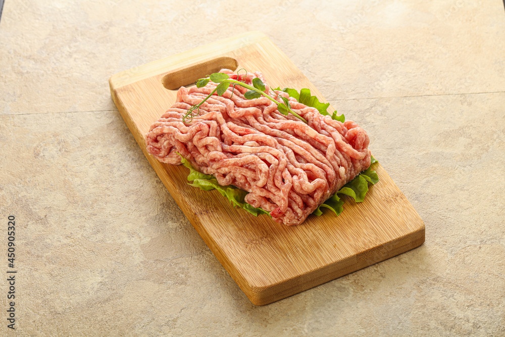 Raw minced pork meat over board
