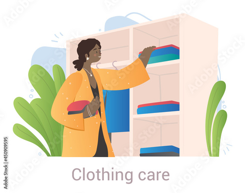 Cute female character is sorting and putting clothes in order in closet on white background. Cheerful clothing shop or showroom stylist is taking care of clothes. Flat cartoon vector illustration