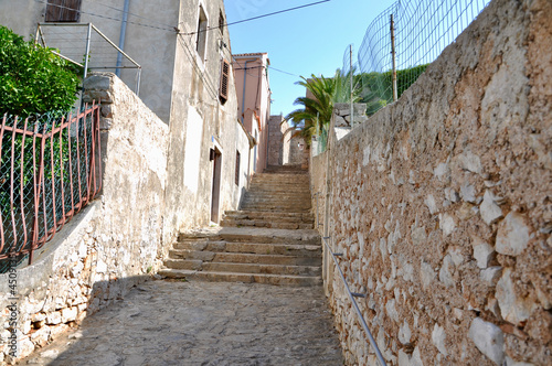 narrow street in the old town of Mali Losinj, Island Losinj, Croatia.Stonemade mediterranean houses in narrow street. photo