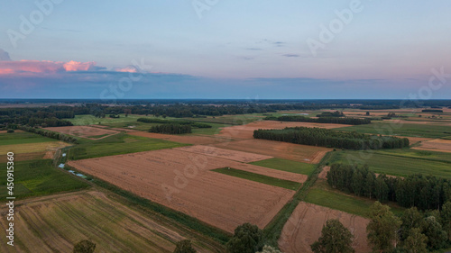 Sunset aerial landscape of filds and meadows