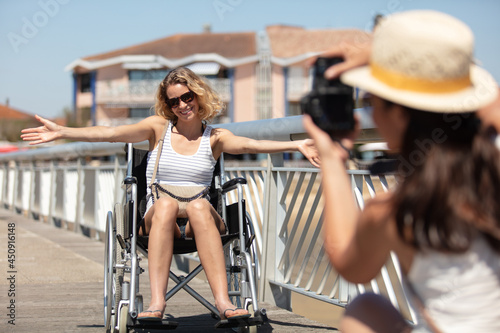 woman in wheelchair posing with arms up
