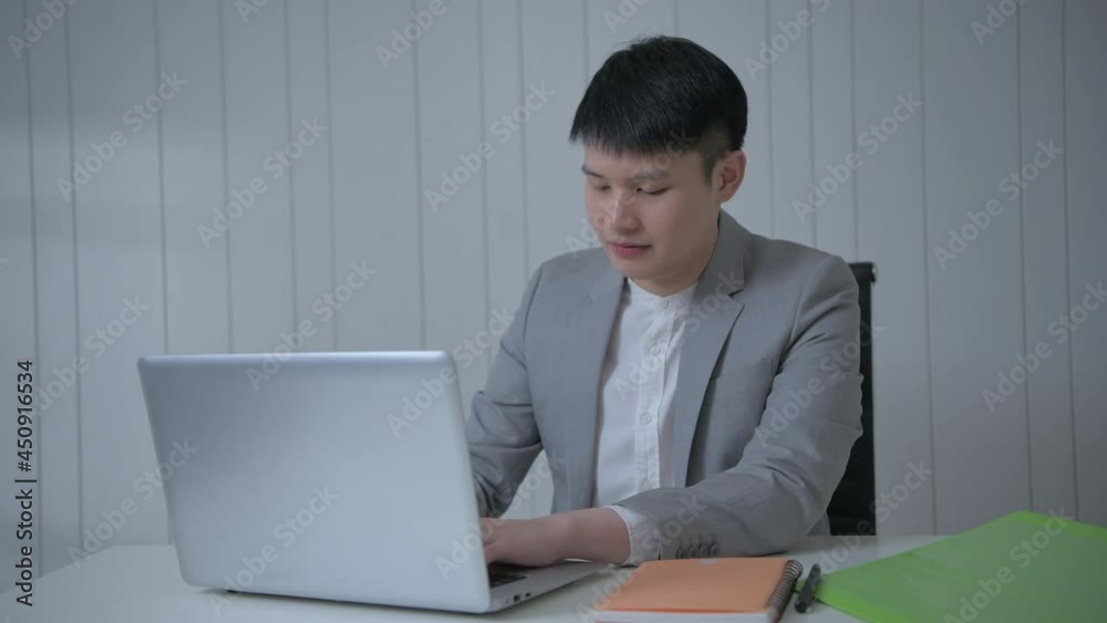 Business concept of 4k Resolution. Young Asian men searching for information using a computer. Business concept of 4k Resolution. Young Asian men searching for information using a computer.