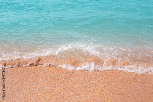 Fototapeta Naklejka Na Ścianę i Meble -  The sea wave runs over the sand. Summer vacation, travel and tourism.