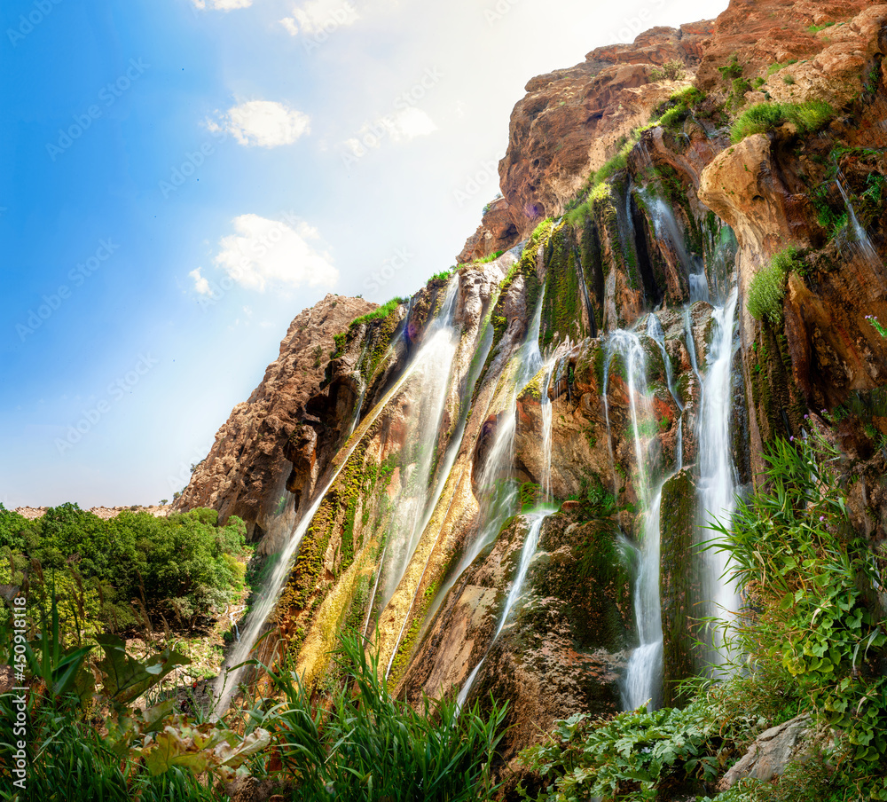 Margoon waterfall in iran. View of tall waterfall surrounded mountains and tress, Sepidan, shiraz province, iran