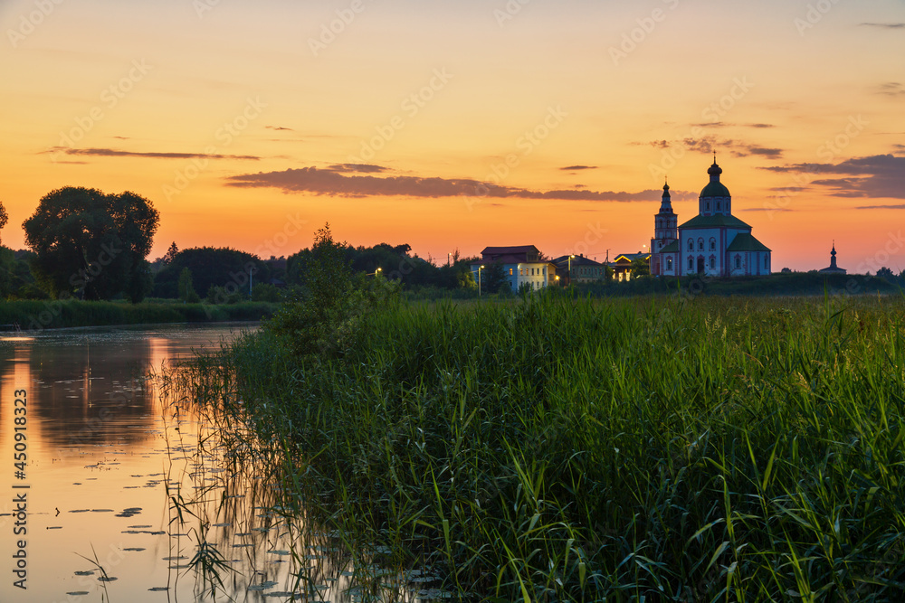 Orthodox church of Elijah the Prophet at the Kamenka river, Suzdal, Russia. Summer sunny day sunset