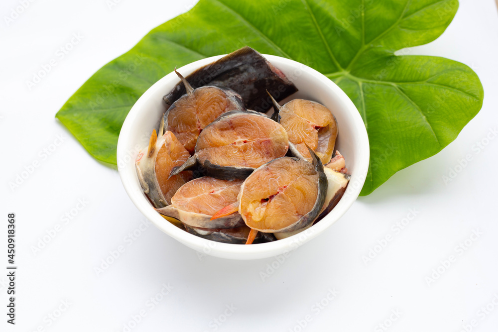 Catfish cut pieces in white bowl on white background. Catfish cut pieces in white bowl on white background.