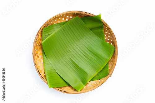 Banana leaf on bamboo basket on white