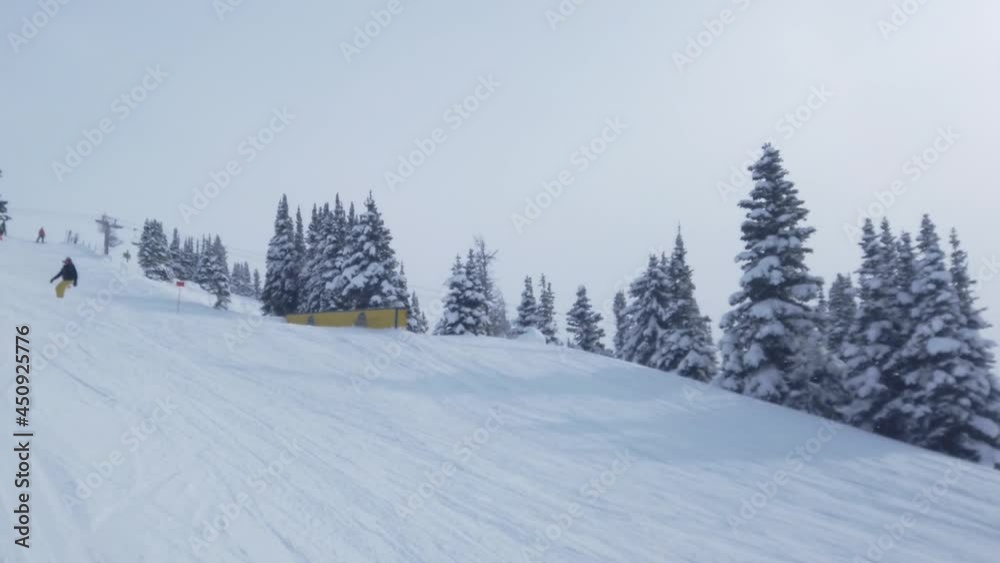 moving shots of snowboarder coming down a hill with a jump at the end moving shots of snowboarder coming down a hill with a jump at the end