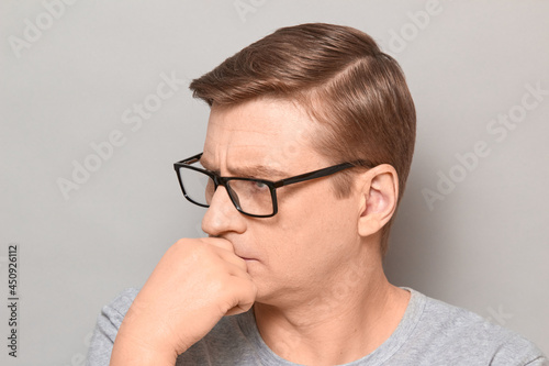Portrait of serious thoughtful blond mature man with glasses
