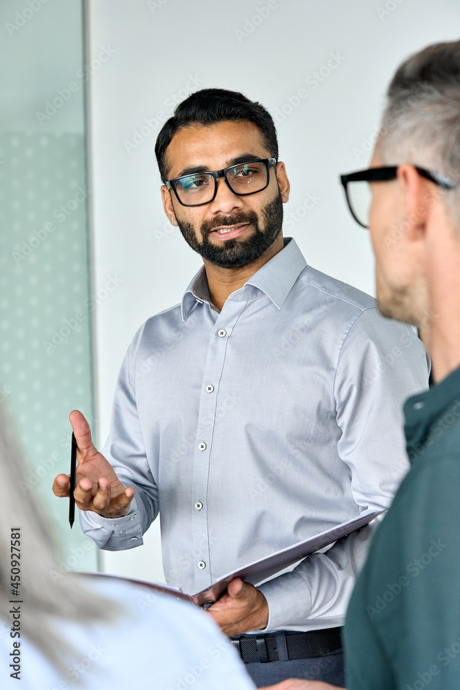 Diverse executive business team group listening to Indian executive ceo