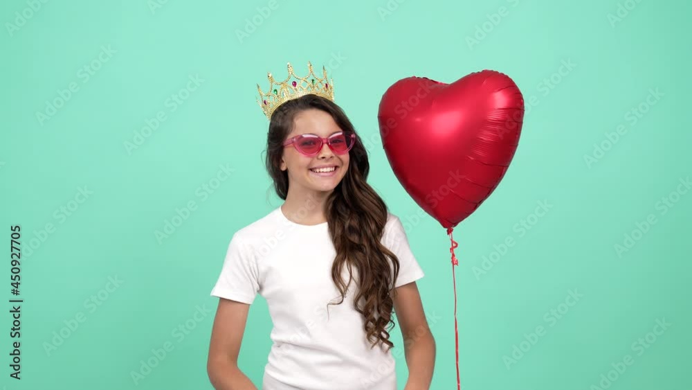 happy laughing kid in sunglasses and crown with heart balloon felt sad after it flew, disappointment
