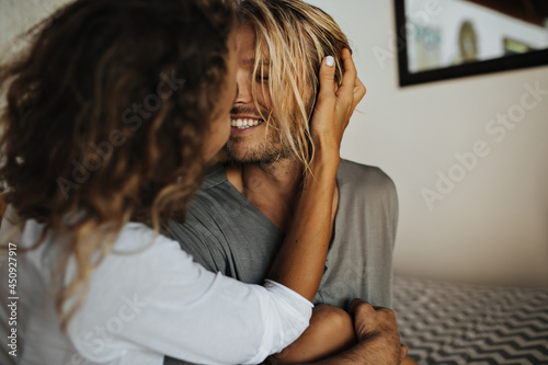 Portrait photo of lovers who kiss in relaxed home environment