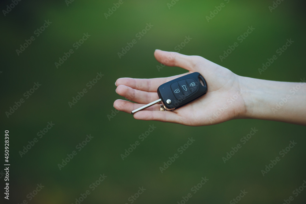 woman holding a car key
