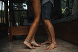 Photos of slender tanned legs of man and woman. Couple dancing in apartment
