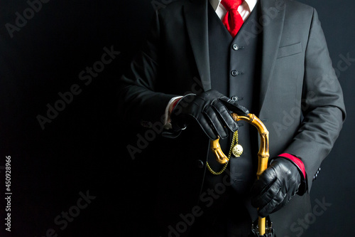 Portrait of Gentleman in Black Suit and Red Tie Holding Umbrella on Black Background. Retro Fashion and Vintage Style. photo