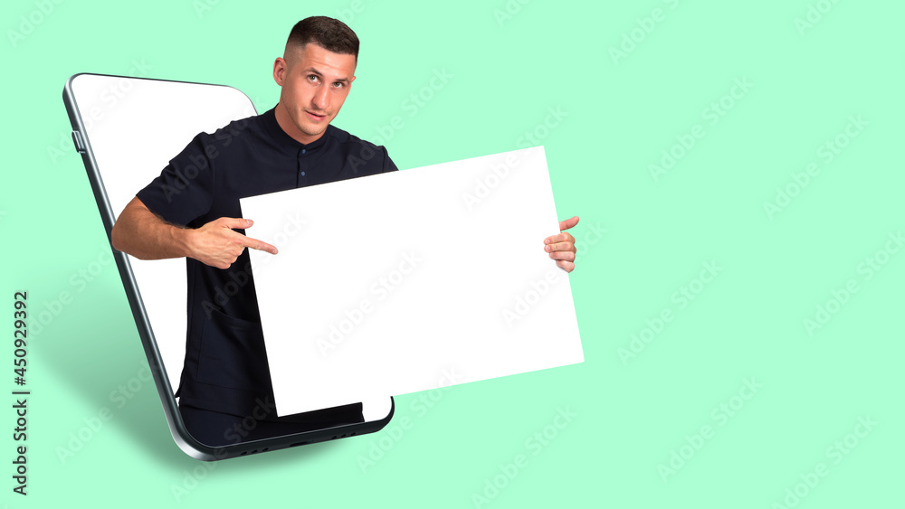 Man pointing to a blank poster. Your advertising copy space. Copy space in hands of a man. White banner with copy space. Guy with a banner on a green background. Art portrait of human in phone Man pointing to a blank poster. Your advertising copy space. Copy space in hands of a man. White banner with copy space. Guy with a banner on a green background. Art portrait of human in phone