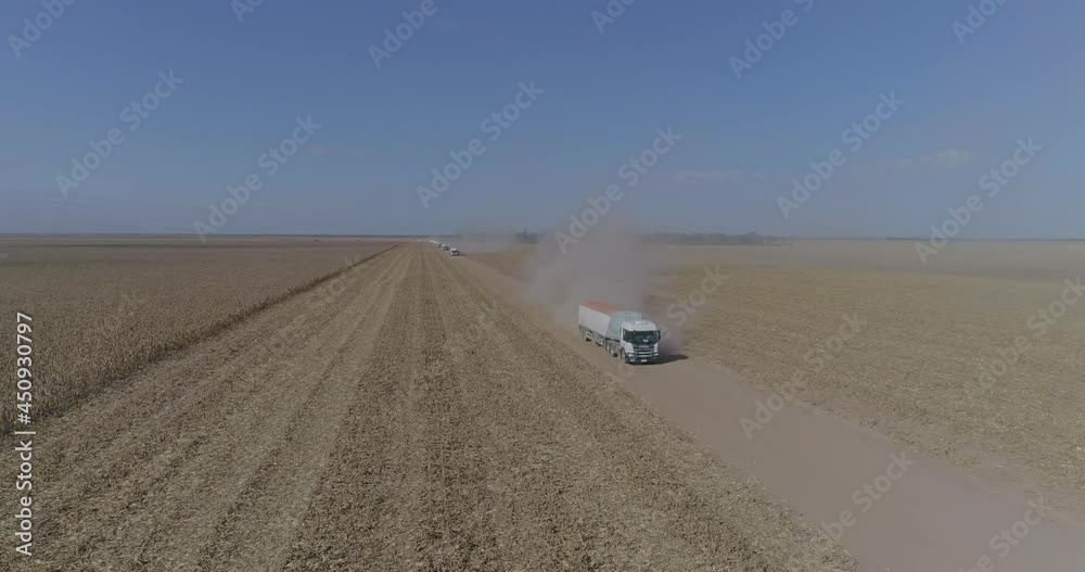 Aerial view of trucks prepared to load corn grains after harvest in the field. Argentina Aerial view of trucks prepared to load corn grains after harvest in the field. Argentina