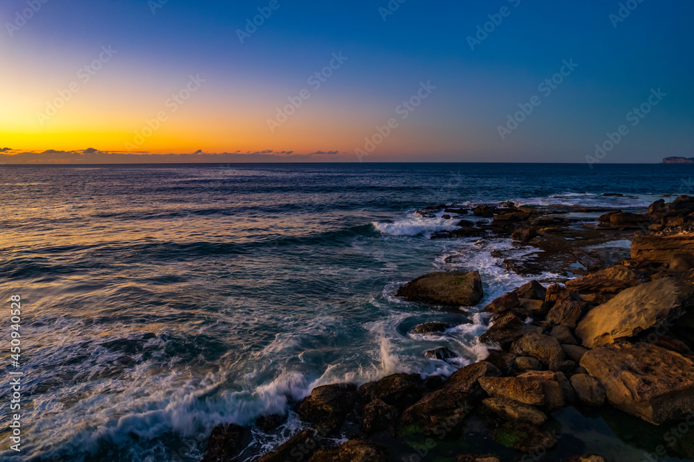 Aerial sunrise over the sea with clear skies