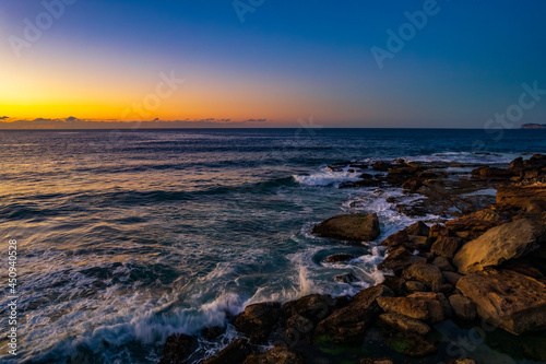 Aerial sunrise over the sea with clear skies