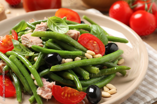 Plate of tasty salad with green beans on table, closeup