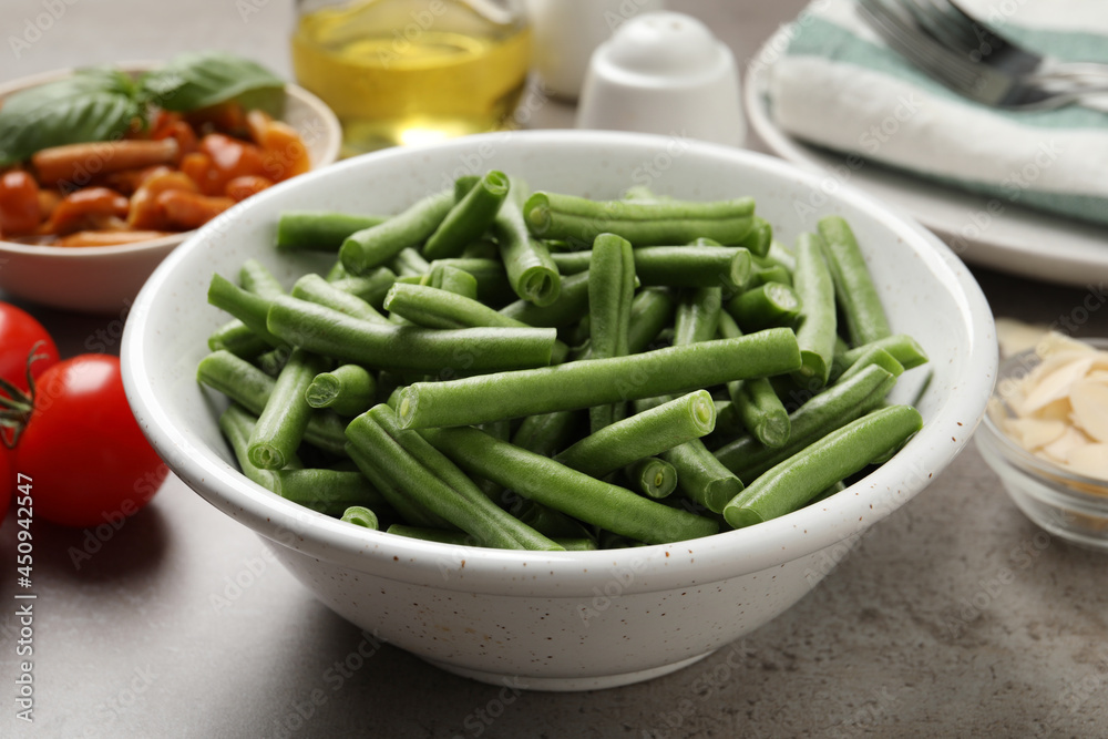 Fresh green beans and other ingredients for salad on grey table Fresh green beans and other ingredients for salad on grey table