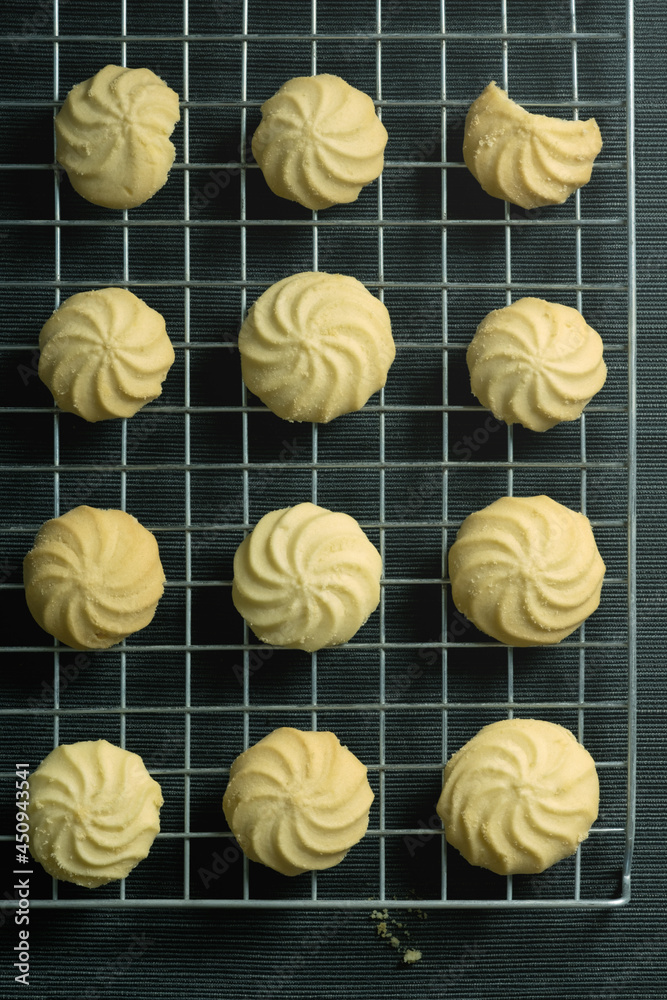 Homemade butter cookies on a wire rack and on the table, top down and vertical view. Homemade butter cookies on a wire rack and on the table, top down and vertical view.