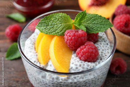 Delicious chia pudding with raspberries  peach and mint in glass  closeup