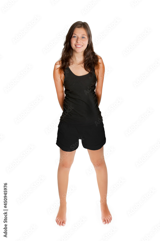 Full length portrait of a beautiful young woman wearing black shorts and top, isolated in front of white studio background Full length portrait of a beautiful young woman wearing black shorts and top, isolated in front of white studio background