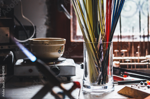 Fragment of a glass-blowing workshop. Colored glass sticks.