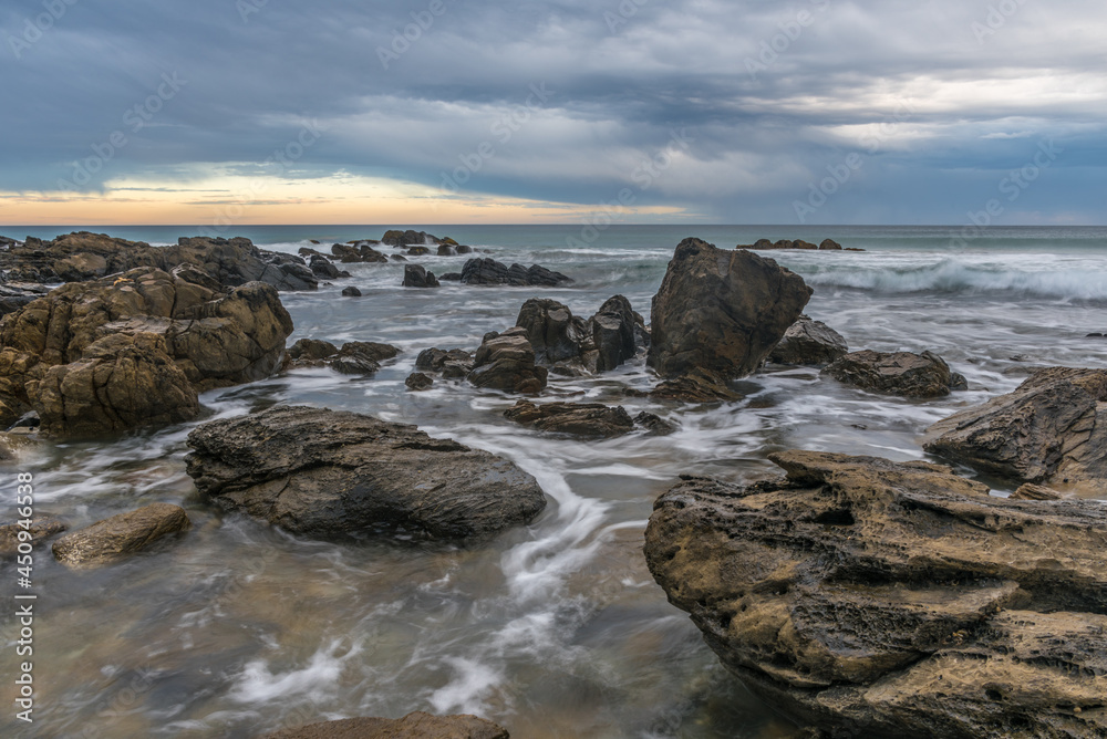 The incoming tide against rocks at Petrel Cove in South Australia The incoming tide against rocks at Petrel Cove in South Australia