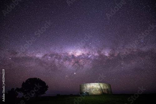 Night sky, with the stars of the Milky Way Galaxy shining over a concrete water tank © Daniel