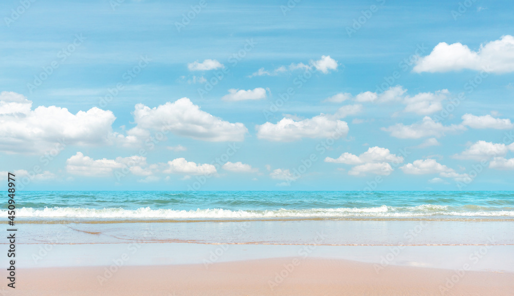 Sand beach on blue sea, white wave under white clouds, pastel blue sky