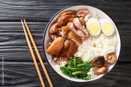 Authentic Thai Recipe for Braised Pork Leg kao kha moo closeup in the bowl on the table. horizontal top view from above