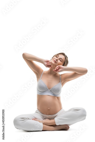 Graceful pregnant woman in white bodysuit relax on background